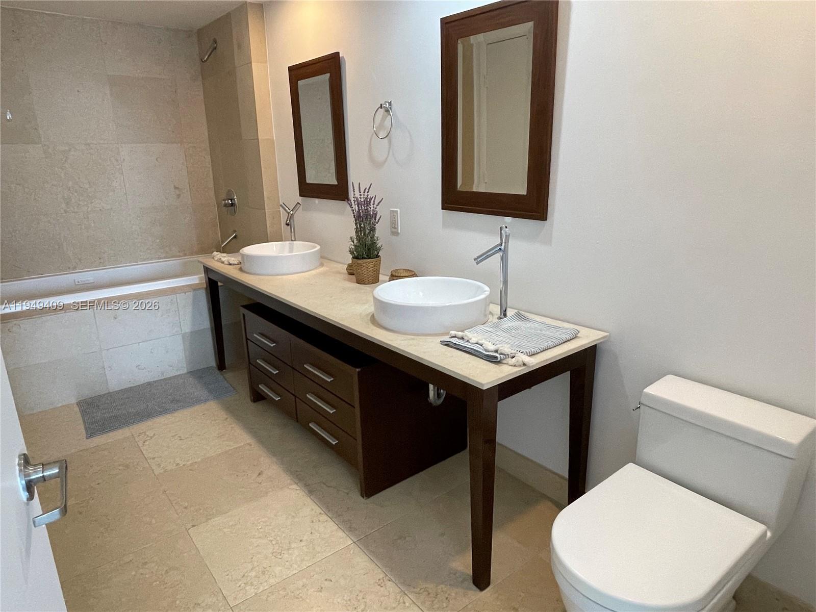 465 Brickell Avenue, Unit 4006 Miami, FL 33131 - Photo 13 of 25 a bathroom with a toilet sink and mirror