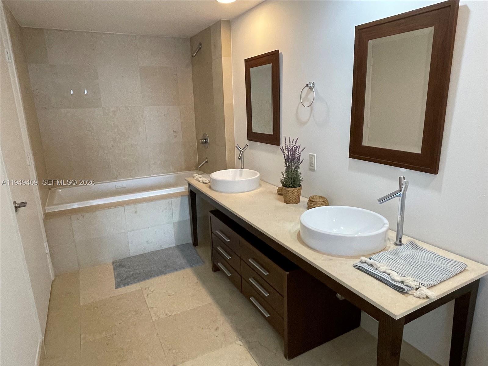 465 Brickell Avenue, Unit 4006 Miami, FL 33131 - Photo 14 of 25 a bathroom with a sink a vanity and a mirror