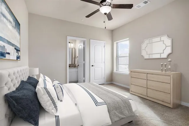 a spacious bedroom with a bed and a chandelier