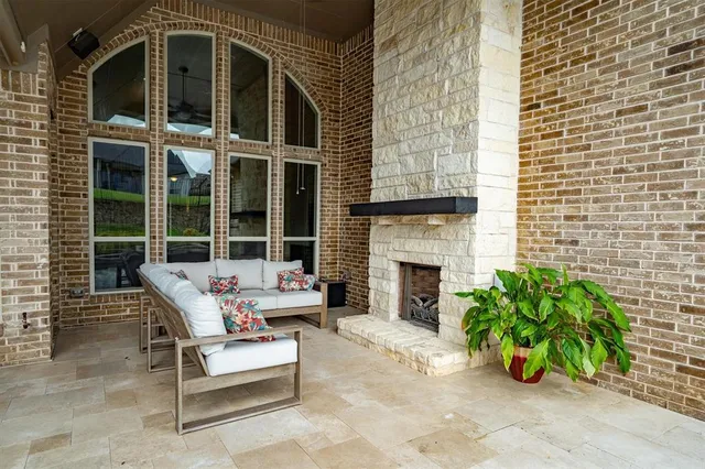 a building outdoor space with patio furniture and potted plants