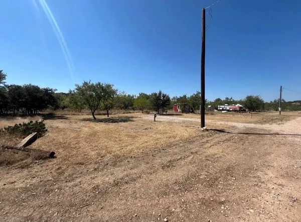a view of a road with a dry yard