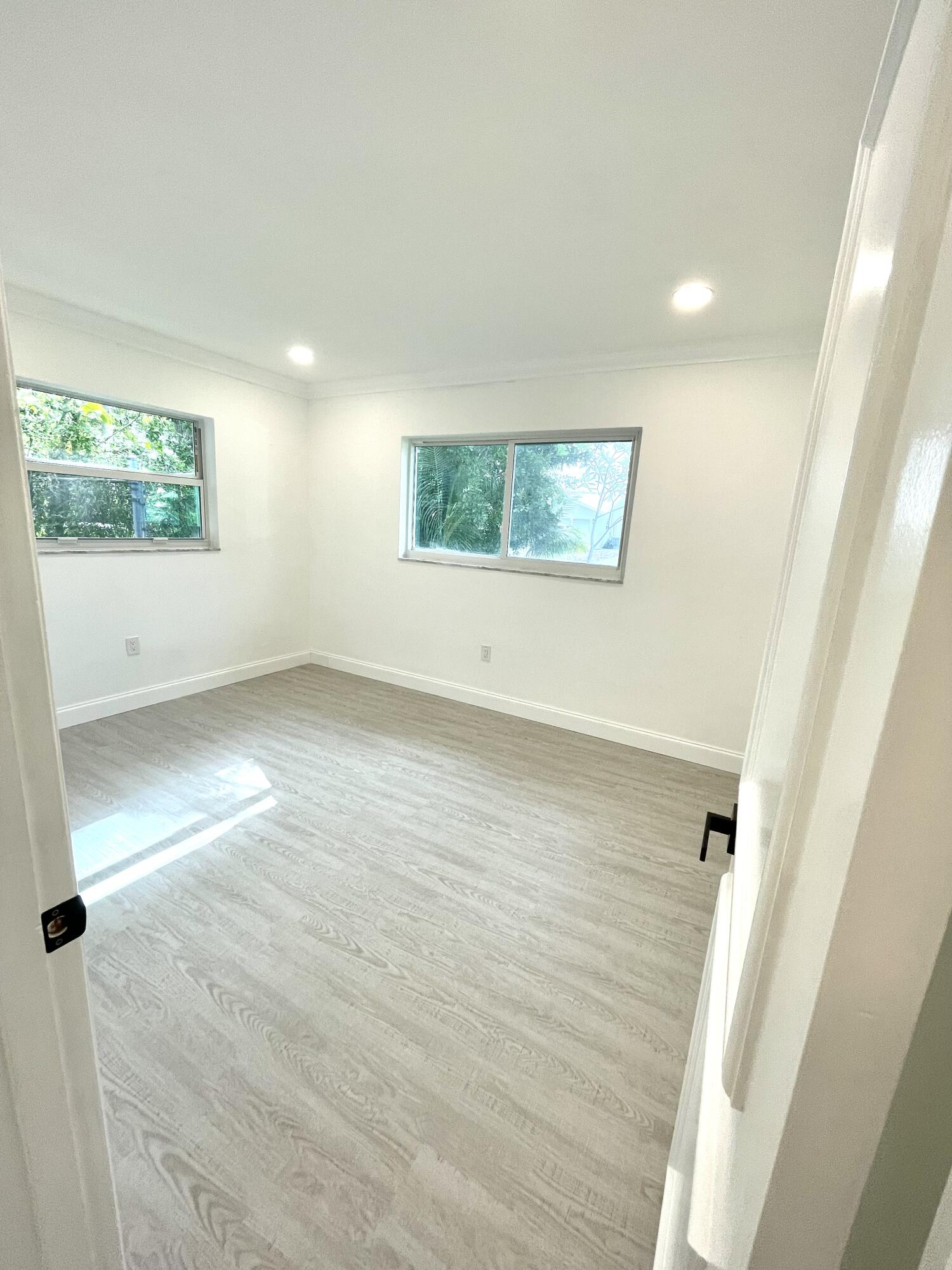 861 Northwest 7th Street Boca Raton, FL 33486 - Photo 12 of 18 an empty room with windows