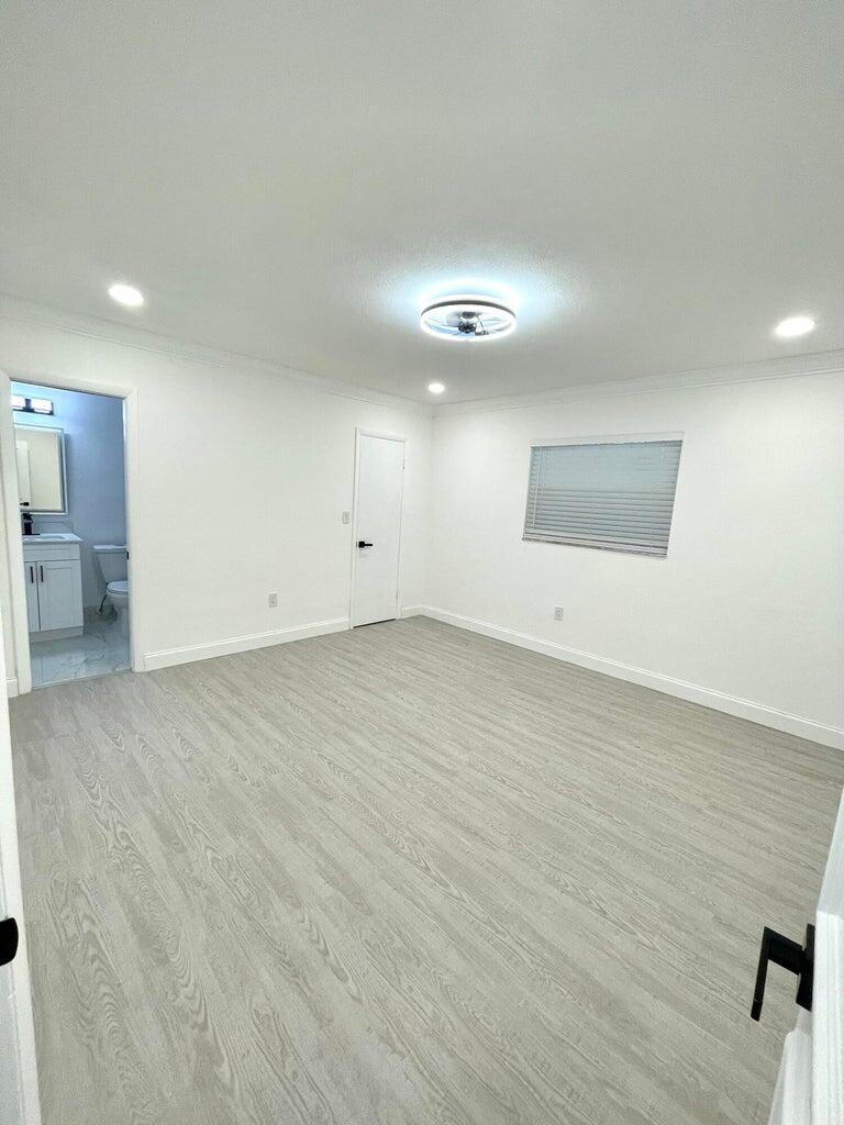 861 Northwest 7th Street Boca Raton, FL 33486 - Photo 15 of 18 an empty room with a workbench