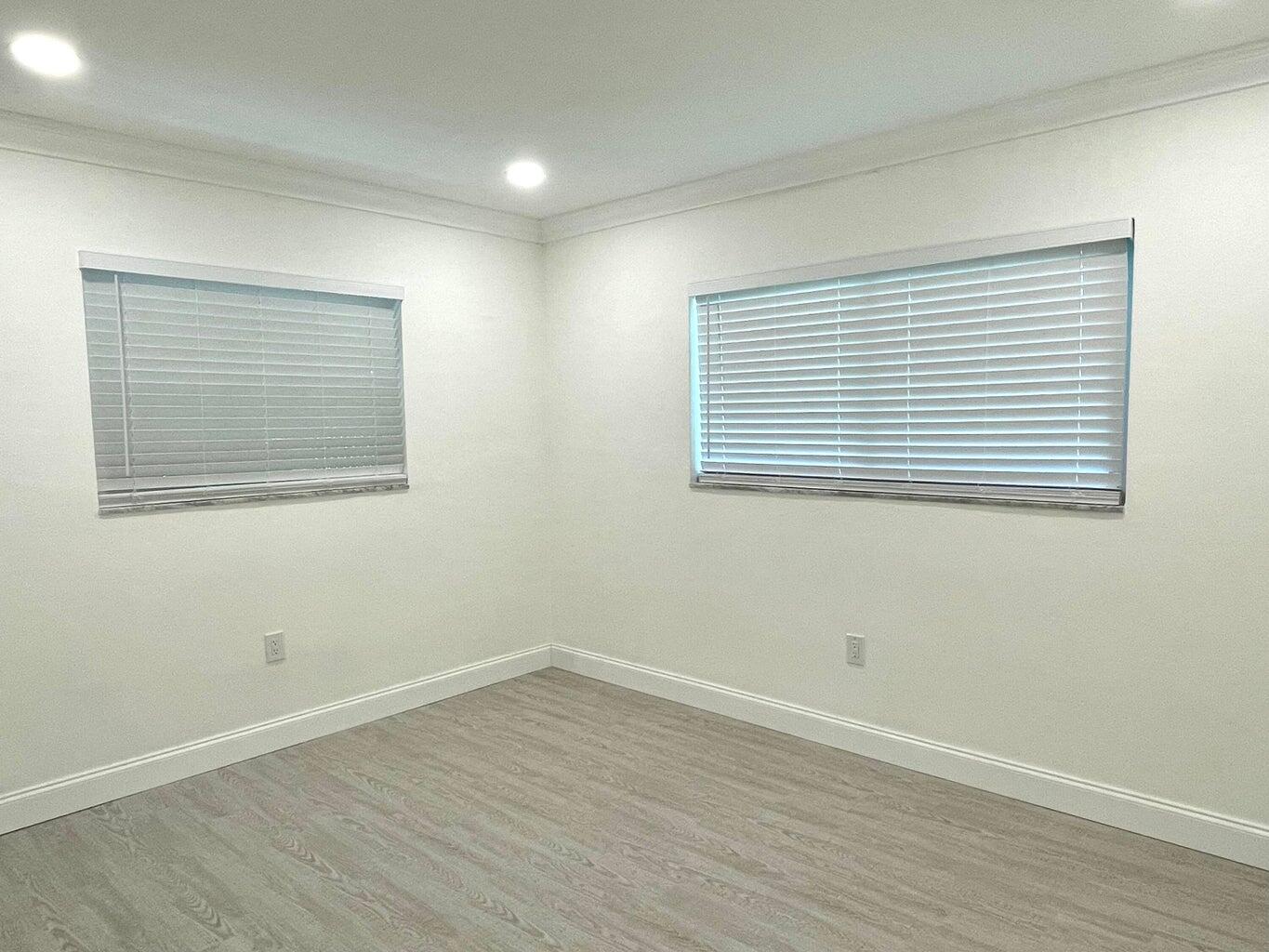 861 Northwest 7th Street Boca Raton, FL 33486 - Photo 16 of 18 a view of an empty room with wooden floor and a window
