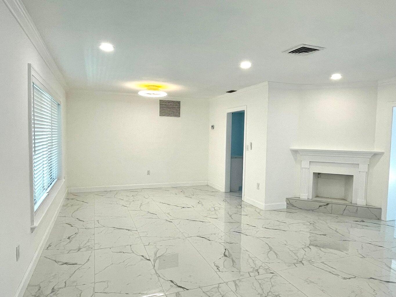 861 Northwest 7th Street Boca Raton, FL 33486 - Photo 5 of 18 a view of an empty room with a fireplace