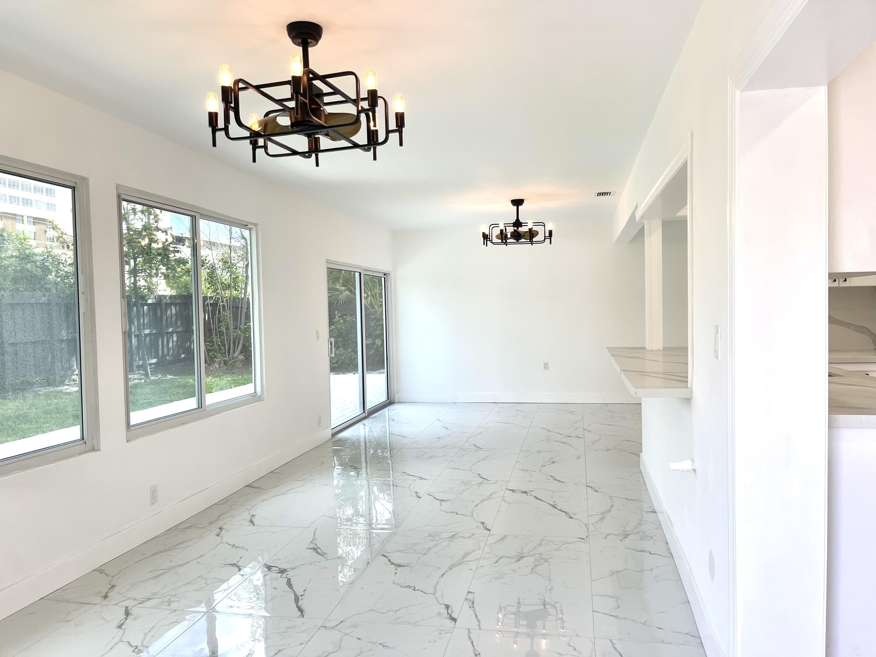 861 Northwest 7th Street Boca Raton, FL 33486 - Photo 7 of 18 a view of a livingroom with a ceiling fan and window