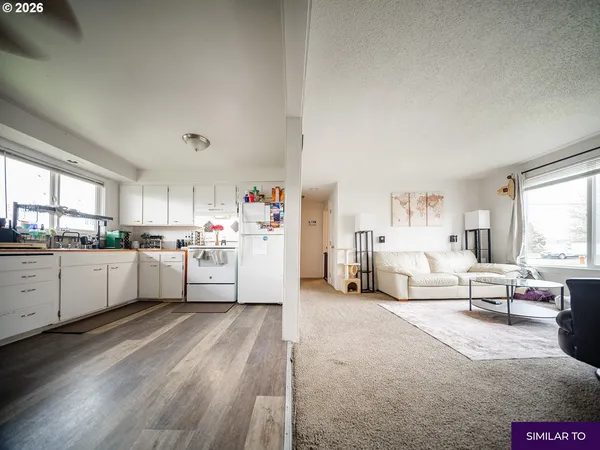 a kitchen with white cabinets and white appliances