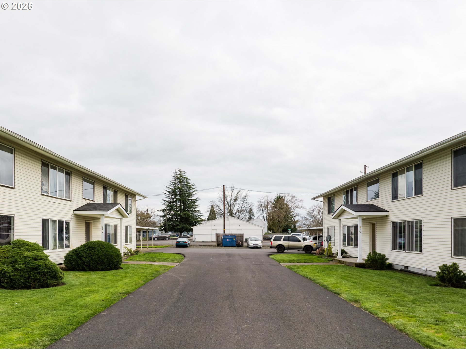 920 18th Avenue Southwest Albany, OR 97321 - Photo 10 of 19 a view of a white house next to a yard with big trees
