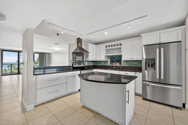 a kitchen with a stove sink and refrigerator