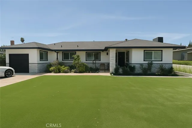 a front view of house with yard and green space