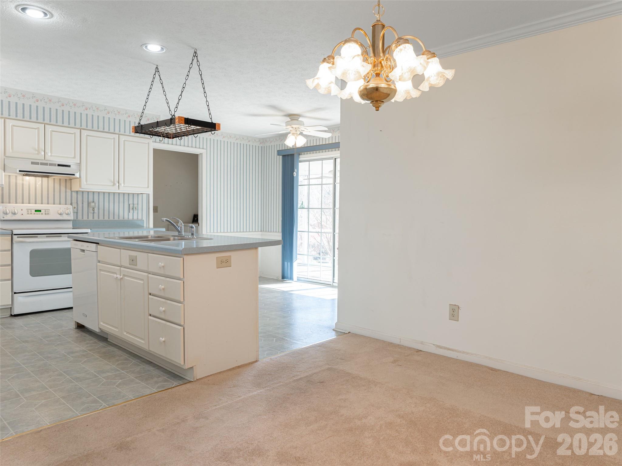 120 Burge Mountain Road Hendersonville, NC 28792 - Photo 12 of 44 a kitchen with a refrigerator a sink dishwasher a stove and white cabinets