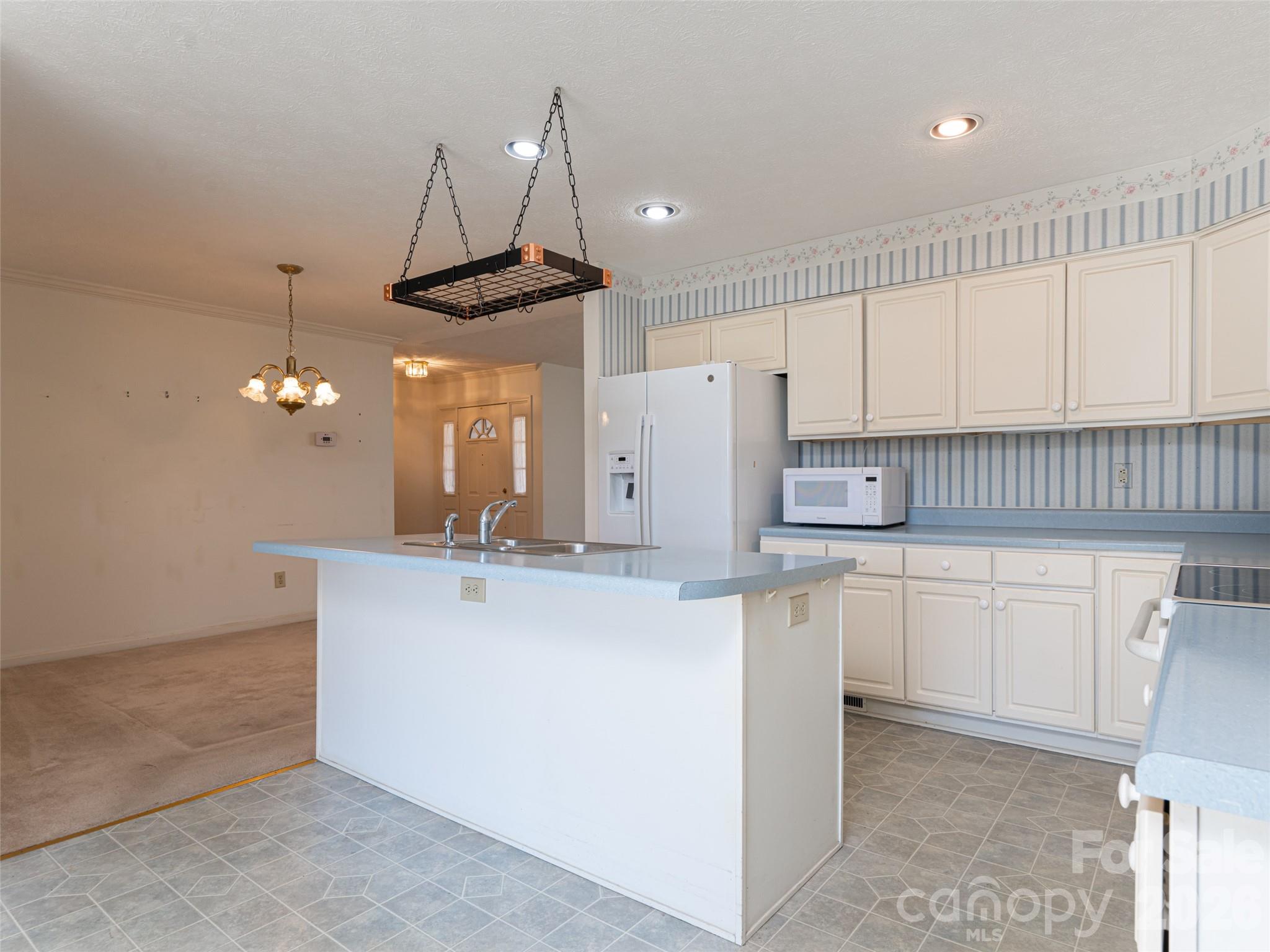 120 Burge Mountain Road Hendersonville, NC 28792 - Photo 18 of 44 a kitchen with stainless steel appliances granite countertop a sink a stove a refrigerator and cabinets