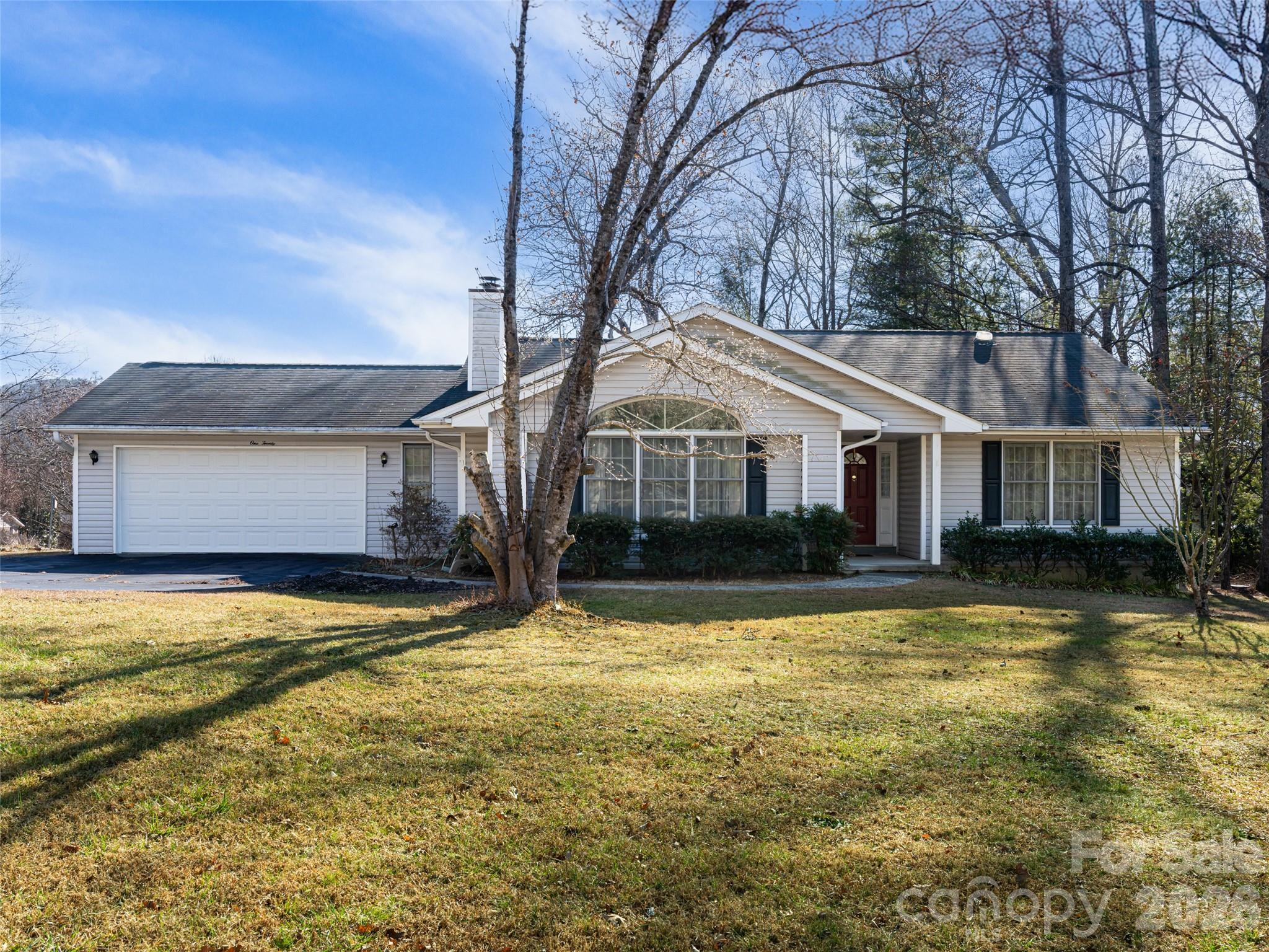 120 Burge Mountain Road Hendersonville, NC 28792 - Photo 2 of 44 a view of a white house with a yard and large tree