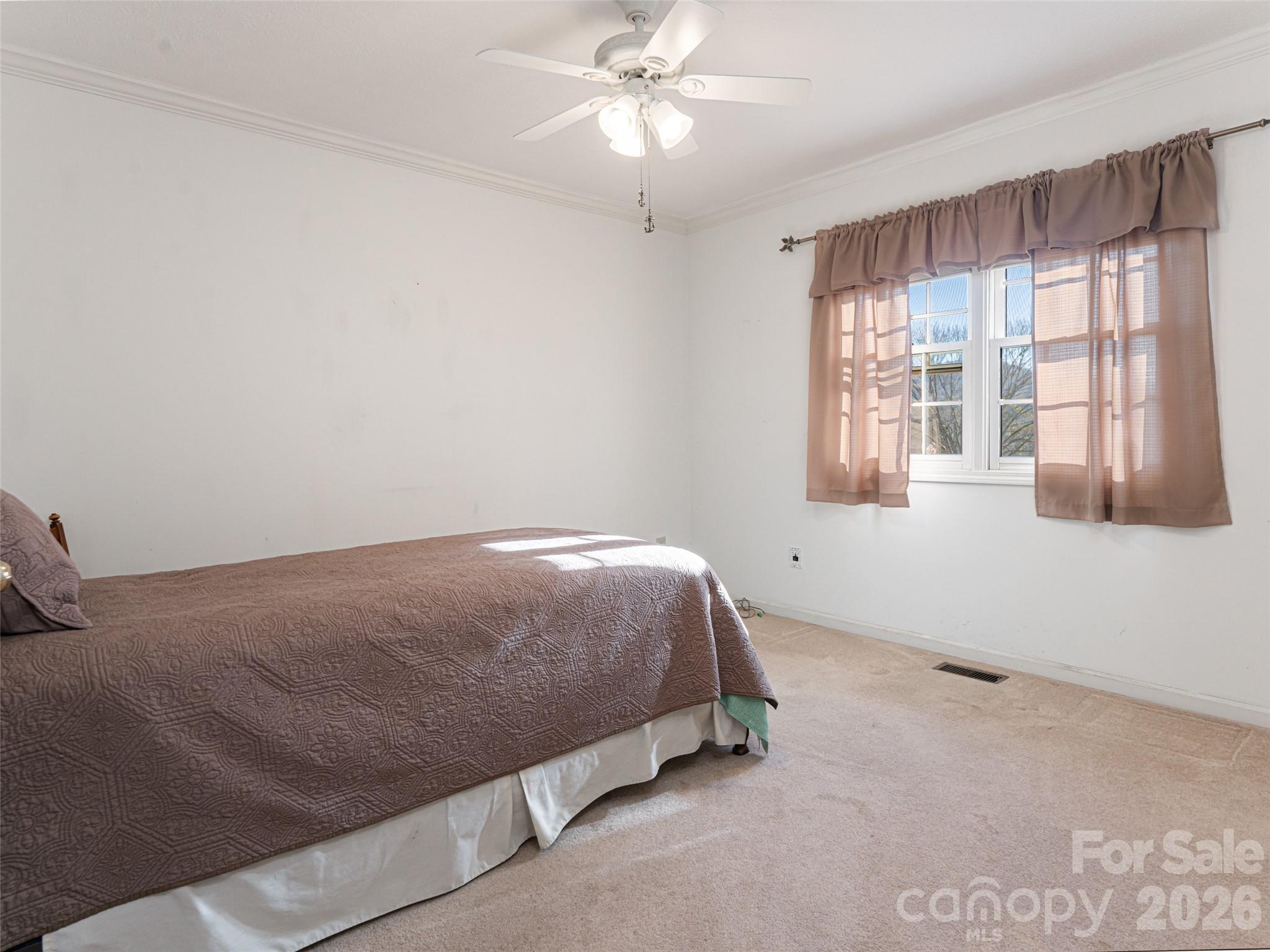 120 Burge Mountain Road Hendersonville, NC 28792 - Photo 26 of 44 a bedroom with a bed and a window