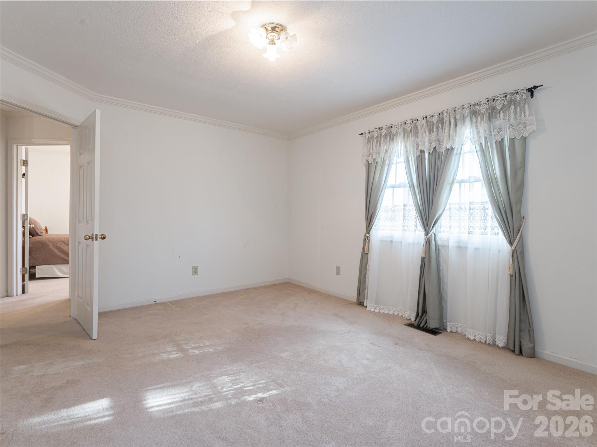 120 Burge Mountain Road Hendersonville, NC 28792 - Photo 30 of 44 an empty room with windows and closet