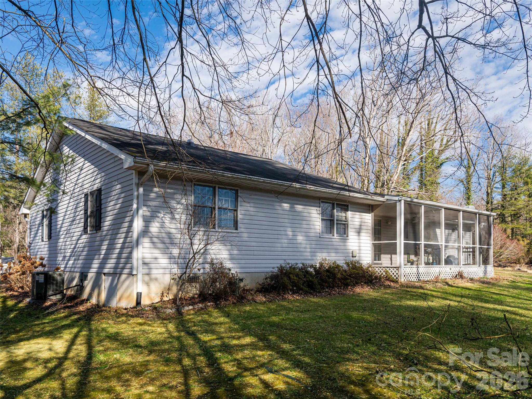 120 Burge Mountain Road Hendersonville, NC 28792 - Photo 41 of 44 a backyard of a house with plants and large tree