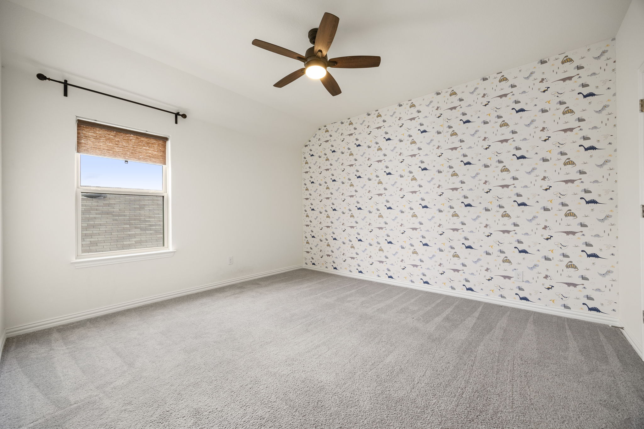 1098 Cherrystone Loop Buda, TX 78610 - Photo 29 of 37 an empty room with a window and a ceiling fan