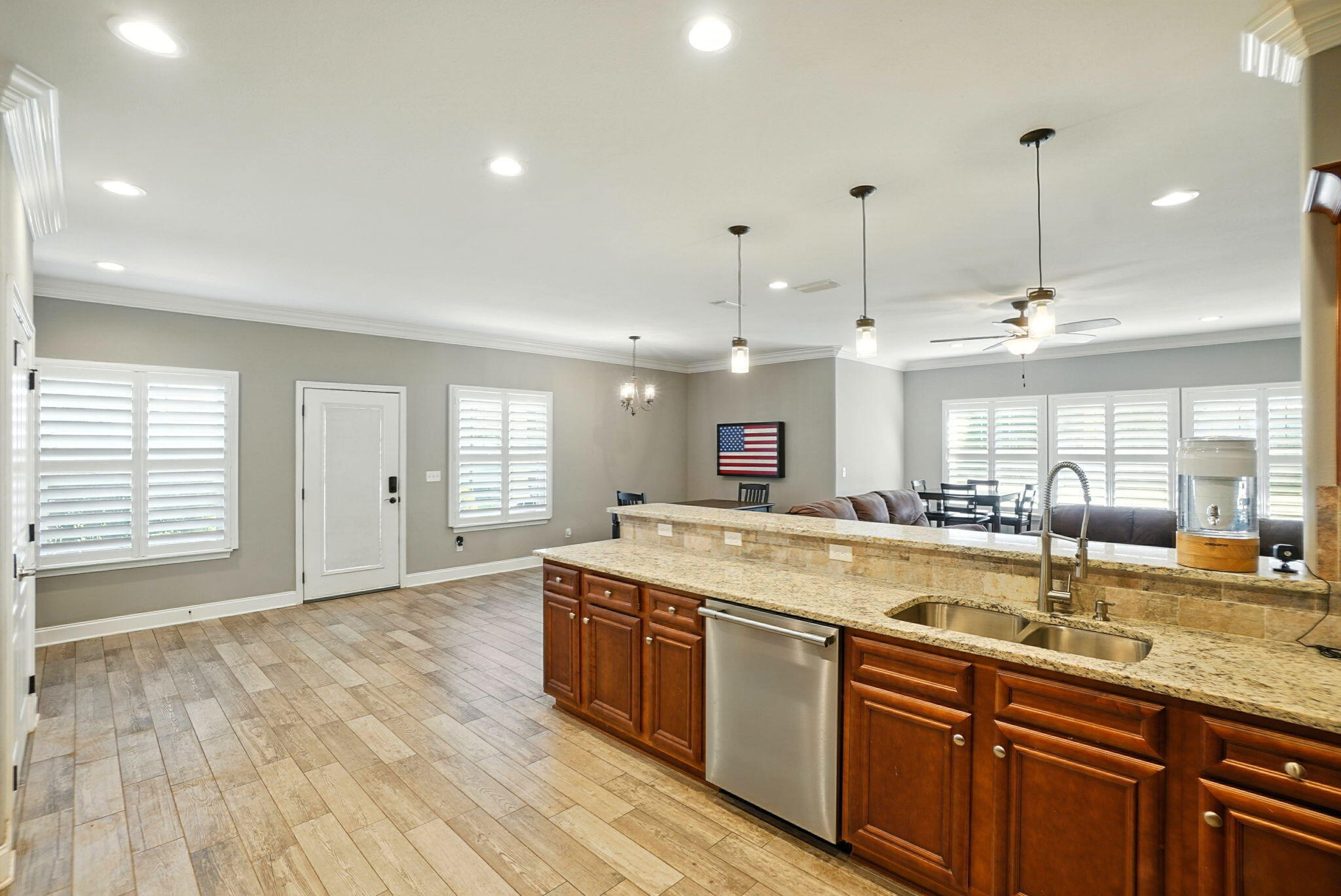 212 Eleases Crossing Crestview, FL 32539 - Photo 13 of 40 a large kitchen with stainless steel appliances granite countertop a sink a stove and a wooden floors