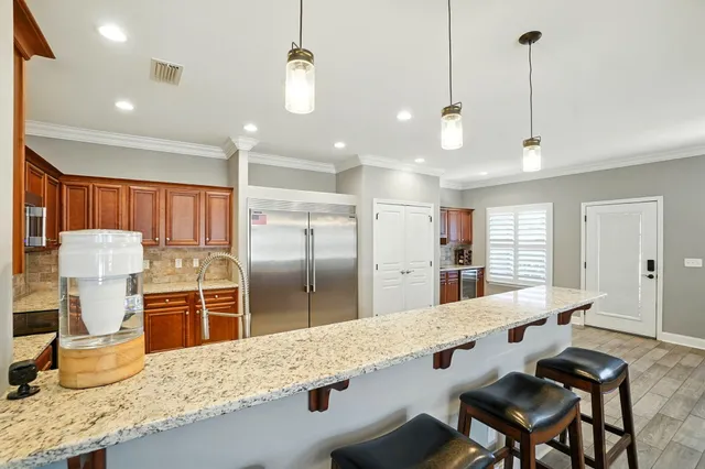 a kitchen with stainless steel appliances kitchen island granite countertop a sink and cabinets