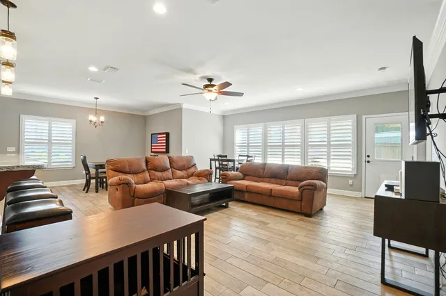 a living room with furniture a wooden floor and a window