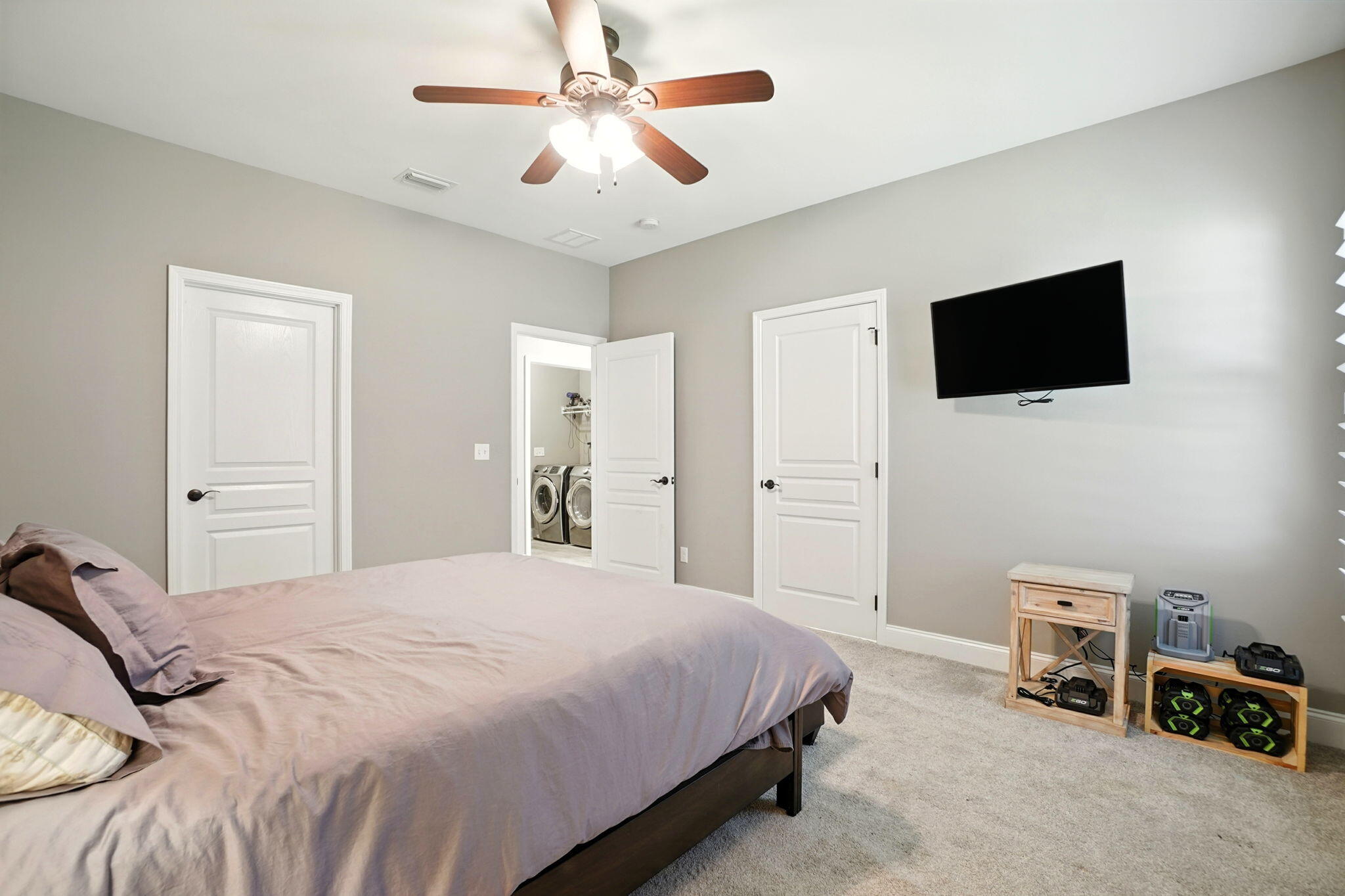 212 Eleases Crossing Crestview, FL 32539 - Photo 24 of 40 a bedroom with a bed a flat screen tv and a chandelier