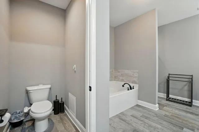 a bathroom with a toilet and a shower