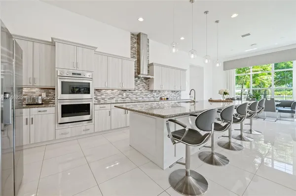 a kitchen with stainless steel appliances a stove sink and cabinets