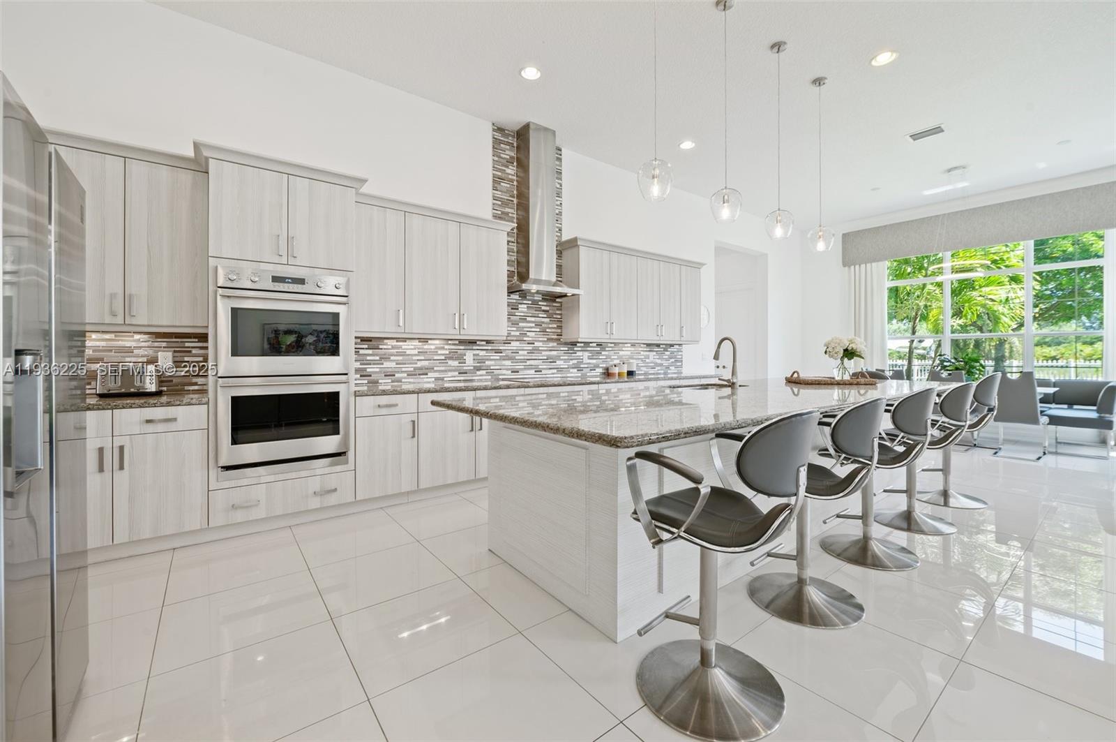 5292 South Sterling Ranch Circle Davie, FL 33314 - Photo 12 of 39 a kitchen with stainless steel appliances a stove sink and cabinets