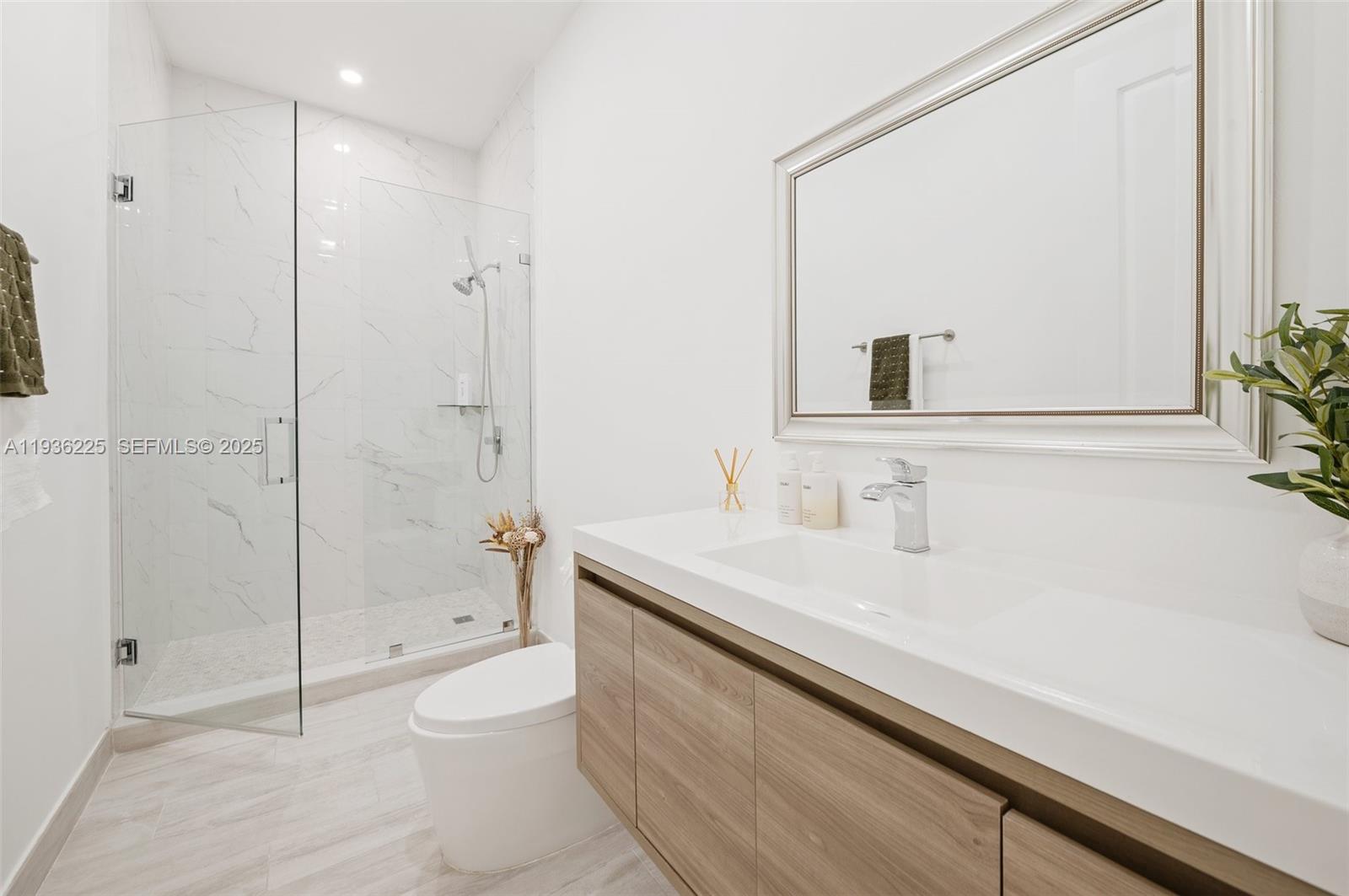 5292 South Sterling Ranch Circle Davie, FL 33314 - Photo 13 of 39 a bathroom with a sink a toilet and shower