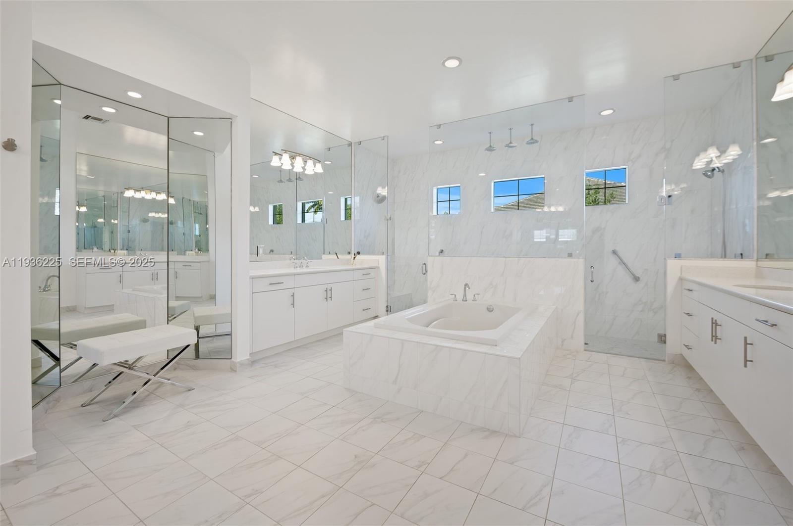 5292 South Sterling Ranch Circle Davie, FL 33314 - Photo 16 of 39 a large white bathroom with a bathtub shower and sink