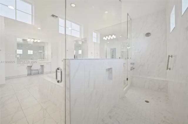 a bathroom with a glass shower door and a shower