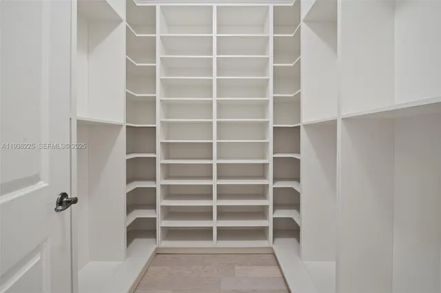 a view of walk in closet with empty racks