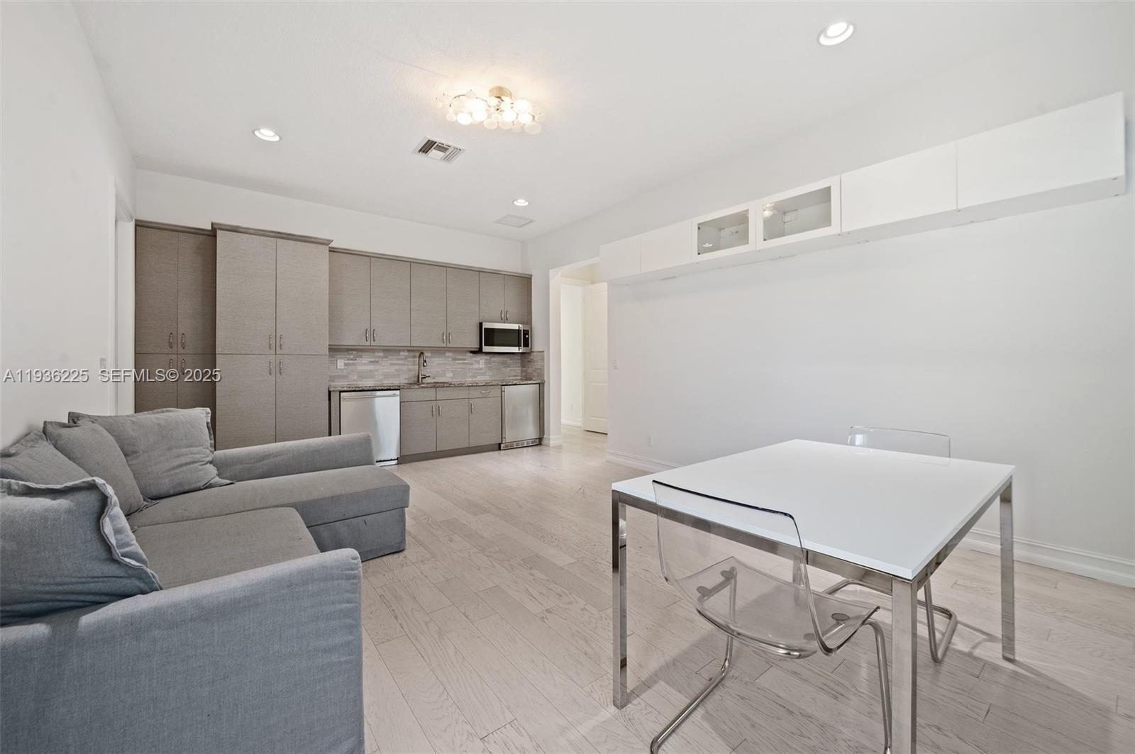 5292 South Sterling Ranch Circle Davie, FL 33314 - Photo 24 of 39 a living room with a couch and a stove top oven