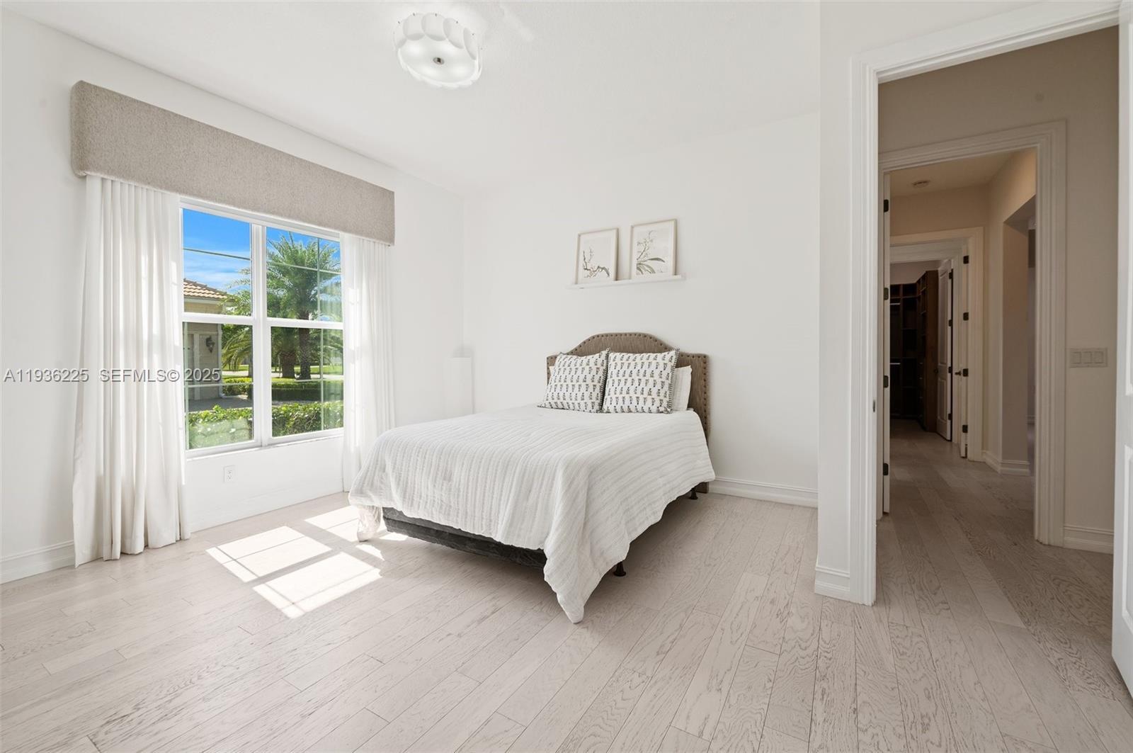 5292 South Sterling Ranch Circle Davie, FL 33314 - Photo 29 of 39 a large bed sitting in a bedroom next to a window