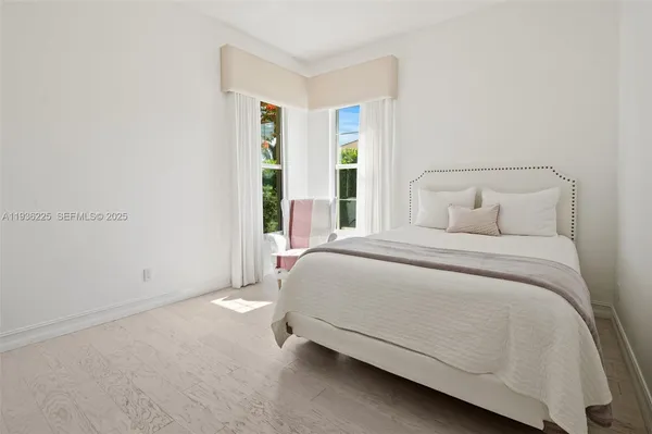 a spacious bedroom with a bed and a window
