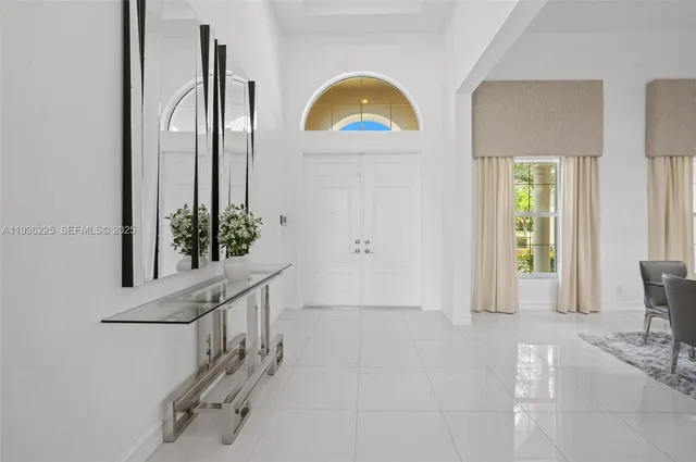 a view of hall way with furniture and window