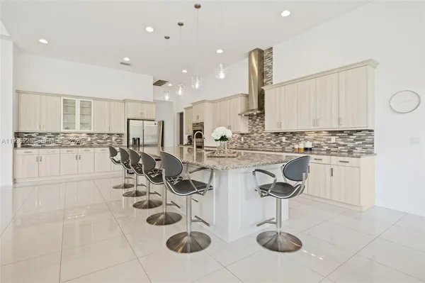 a kitchen with cabinets and chairs