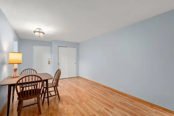 a view of a dining room with furniture and a window