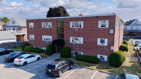 a car parked in front of a brick building