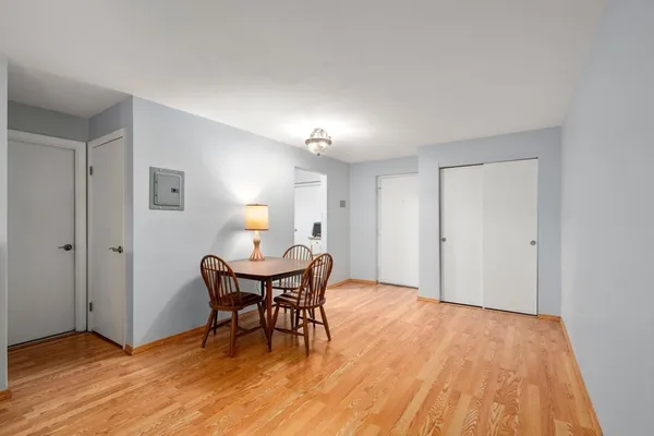 a view of a dining room with furniture and wooden floor