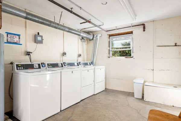 a room with sink washer and dryer