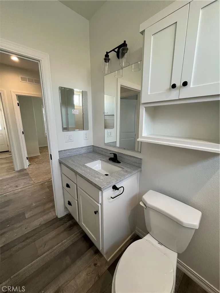 1550 Rimpau, Unit 42 Corona, CA 92881 - Photo 11 of 22 a view of bathroom with toilet sink and mirror