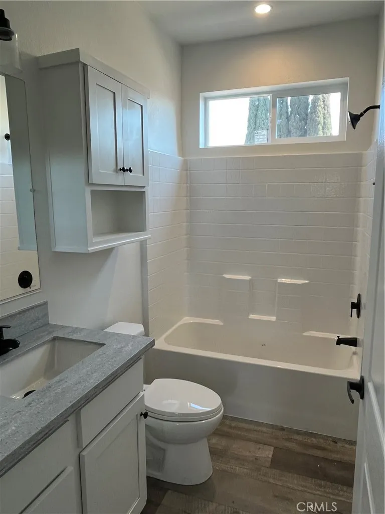 1550 Rimpau, Unit 42 Corona, CA 92881 - Photo 12 of 22 a bathroom with a sink a toilet and shower