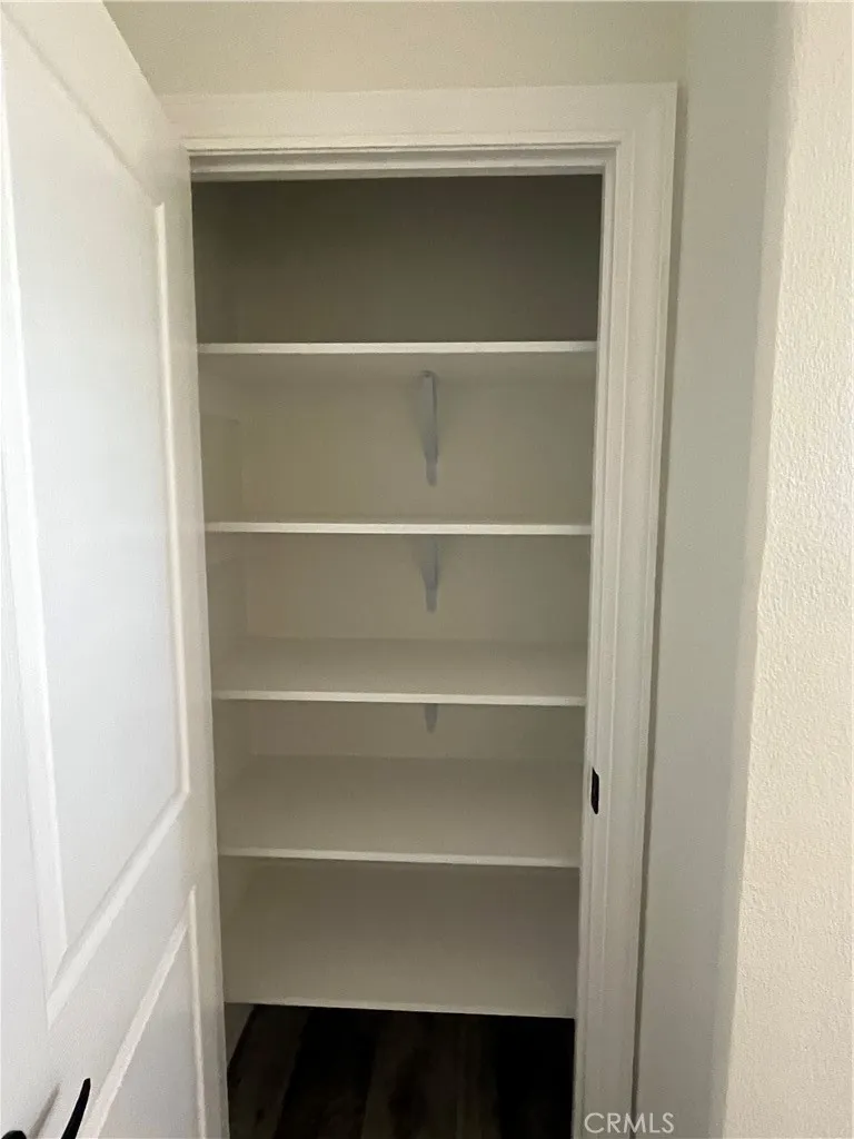 1550 Rimpau, Unit 42 Corona, CA 92881 - Photo 16 of 22 a view of walk in closet with empty racks