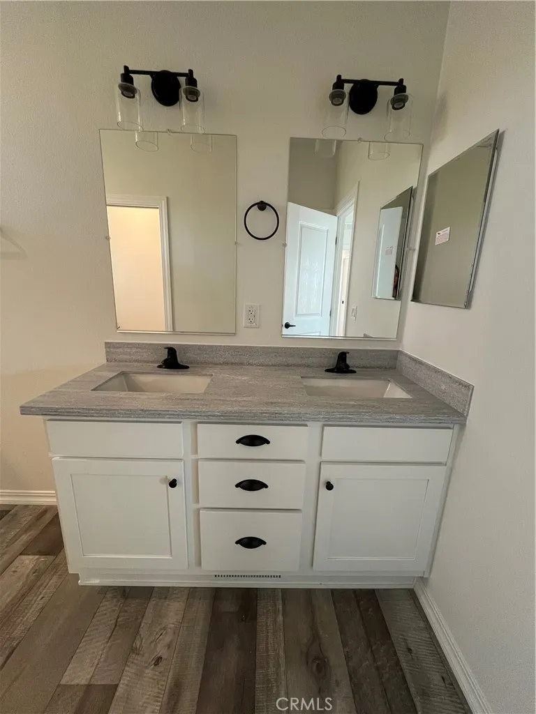 1550 Rimpau, Unit 42 Corona, CA 92881 - Photo 18 of 22 a bathroom with a sink and a mirror