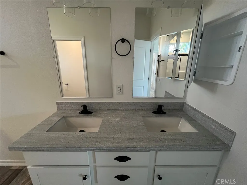 1550 Rimpau, Unit 42 Corona, CA 92881 - Photo 19 of 22 a bathroom with a sink and a mirror