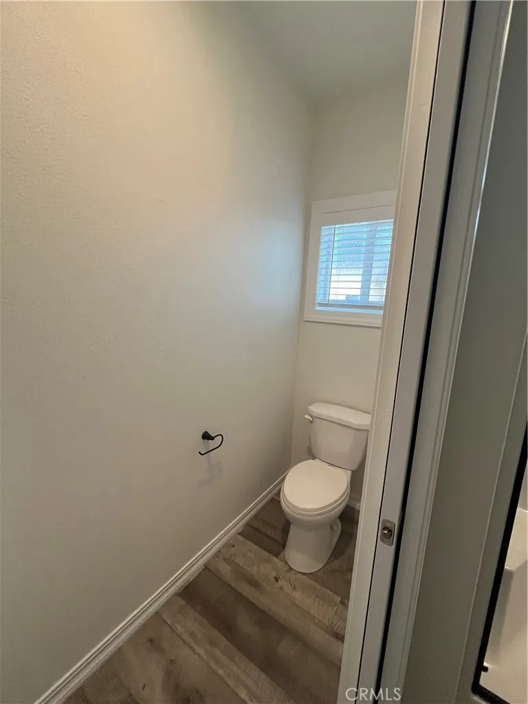 1550 Rimpau, Unit 42 Corona, CA 92881 - Photo 20 of 22 a bathroom with a granite countertop toilet and a sink