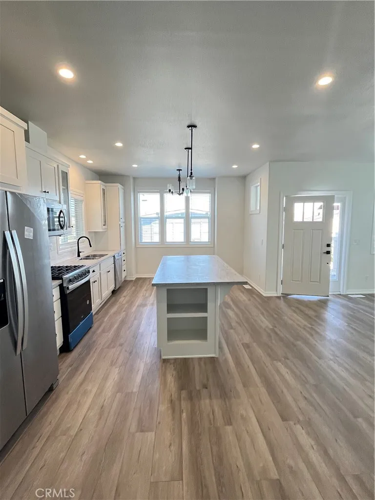 1550 Rimpau, Unit 42 Corona, CA 92881 - Photo 2 of 22 a kitchen with stainless steel appliances granite countertop a refrigerator a stove and a wooden floors