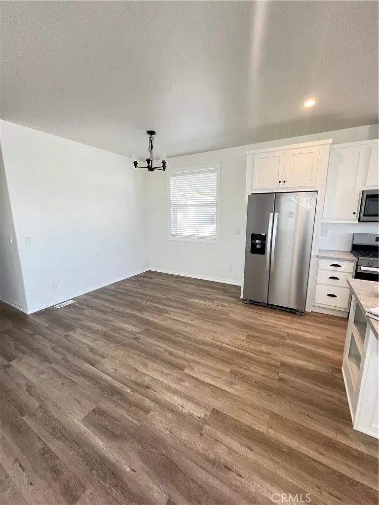 1550 Rimpau, Unit 42 Corona, CA 92881 - Photo 5 of 22 a view of a kitchen with a sink and a refrigerator