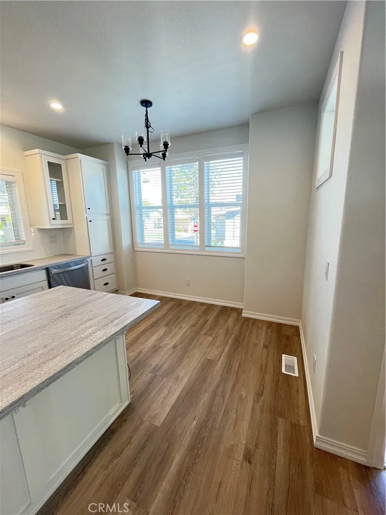 1550 Rimpau, Unit 42 Corona, CA 92881 - Photo 6 of 22 an empty room with wooden floor and windows